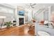 Living room boasts fireplace, hardwood flooring, staircase, and a neutral gray sectional couch at 2685 Grady Se St, Smyrna, GA 30080