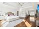 Expansive main bedroom with tray ceiling, hardwood floors, and a dedicated desk area at 2685 Grady Se St, Smyrna, GA 30080
