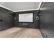 Modern media room with projector screen, built-in speakers, and wood flooring at 2685 Grady Se St, Smyrna, GA 30080