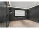 Dark painted media room with projector screen and built-in speakers at 2685 Grady Se St, Smyrna, GA 30080