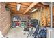 A cluttered storage area with exposed wood beams, brick wall, and many stored items at 2685 Grady Se St, Smyrna, GA 30080
