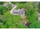 An aerial view of this home shows a well maintained roof, outdoor patio area, mature trees and manicured landscaping at 452 Brushstroke Se Ct, Marietta, GA 30067