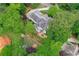 This aerial image showcases a well-maintained roof, outdoor patio area, mature trees and manicured landscaping at 452 Brushstroke Se Ct, Marietta, GA 30067
