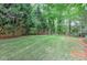 Backyard features lush green grass, mature trees and a designated area for an above-ground pool at 452 Brushstroke Se Ct, Marietta, GA 30067