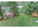 Backyard features include lush green grass, landscaping, and an elegant house with a three-car garage at 452 Brushstroke Se Ct, Marietta, GA 30067