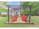 Relaxing backyard area with pergola, string lights and Adirondack chairs, perfect for outdoor enjoyment at 452 Brushstroke Se Ct, Marietta, GA 30067