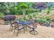 Charming backyard patio area featuring a table and chairs, surrounded by lush landscaping at 452 Brushstroke Se Ct, Marietta, GA 30067
