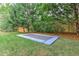 Backyard features lush green grass, mature trees and a sunken trampoline at 452 Brushstroke Se Ct, Marietta, GA 30067