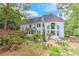 Beautiful backyard featuring a large house, colorful flowers, and mature trees at 452 Brushstroke Se Ct, Marietta, GA 30067