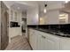 A basement bar boasts granite countertops, white cabinets, and stainless steel appliances at 452 Brushstroke Se Ct, Marietta, GA 30067