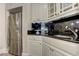 A basement wet bar featuring granite countertop, stainless steel refrigerator and modern sink and faucet at 452 Brushstroke Se Ct, Marietta, GA 30067
