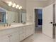 Bright bathroom features white cabinets, double sinks, and open doorway at 452 Brushstroke Se Ct, Marietta, GA 30067