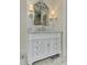 Close up of bathroom vanity with marble countertop and decorative mirror, plus sconces at 452 Brushstroke Se Ct, Marietta, GA 30067