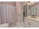 Bright bathroom with tile flooring, patterned shower curtain, and white vanity at 452 Brushstroke Se Ct, Marietta, GA 30067