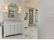 Elegant bathroom vanity with marble countertop, decorative mirror and sconces, plus a marble shower at 452 Brushstroke Se Ct, Marietta, GA 30067