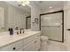 Bathroom features a white vanity, framed mirror, and walk-in shower with glass door at 452 Brushstroke Se Ct, Marietta, GA 30067