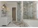 Bright bathroom with double vanity, marble countertops, glass shower and bathtub at 452 Brushstroke Se Ct, Marietta, GA 30067