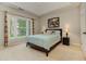 Cozy bedroom with natural light, a tray ceiling, and neutral-toned walls at 452 Brushstroke Se Ct, Marietta, GA 30067