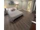 Comfortable bedroom featuring wood-look floors and access to an adjoining bathroom for added convenience at 452 Brushstroke Se Ct, Marietta, GA 30067