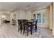 Open-concept dining room with hardwood floors, bar stools and large windows at 452 Brushstroke Se Ct, Marietta, GA 30067