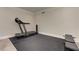 Basement exercise room with treadmill and workout bench on black rubber flooring at 452 Brushstroke Se Ct, Marietta, GA 30067