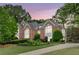 Stunning brick home featuring manicured landscaping, a gabled roof, and prominent arched windows at 452 Brushstroke Se Ct, Marietta, GA 30067