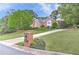 Picturesque home with manicured lawn and mature trees, complemented by a brick mailbox at 452 Brushstroke Se Ct, Marietta, GA 30067