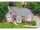 Aerial view of brick home showcasing architectural details, including arched windows, gables and manicured landscaping at 452 Brushstroke Se Ct, Marietta, GA 30067