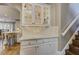Bright foyer with wooden floors, leading to the kitchen, and a staircase with white banisters at 452 Brushstroke Se Ct, Marietta, GA 30067