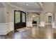 Inviting foyer with hardwood floors and a view of a home office through an archway at 452 Brushstroke Se Ct, Marietta, GA 30067