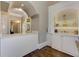 Charming foyer with custom built-in shelving, cabinets, and elegant decor on hardwood floors at 452 Brushstroke Se Ct, Marietta, GA 30067