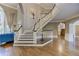 Stately foyer showcasing a staircase, hardwood floors, and a view into adjacent living spaces and second stairway at 452 Brushstroke Se Ct, Marietta, GA 30067