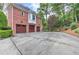A three car garage with paneled doors provides ample parking at 452 Brushstroke Se Ct, Marietta, GA 30067