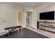 Home gym featuring a weight bench, a large screen TV, and gray flooring at 452 Brushstroke Se Ct, Marietta, GA 30067