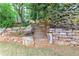 Stone steps framed by a retaining wall and lush landscaping, enhance the property's curb appeal at 452 Brushstroke Se Ct, Marietta, GA 30067