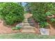 Stone steps surrounded by mature bushes offer a pathway through the beautifully landscaped yard at 452 Brushstroke Se Ct, Marietta, GA 30067