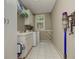 A laundry room with white cabinets, sink, a washer, a dryer and a window at 452 Brushstroke Se Ct, Marietta, GA 30067