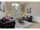 Elegant living room with vaulted ceilings, tall windows with shutters, and a luxurious chandelier at 452 Brushstroke Se Ct, Marietta, GA 30067