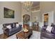 Warm living room featuring dark wood floors, a classic chandelier, and stairs to the second floor at 452 Brushstroke Se Ct, Marietta, GA 30067