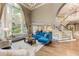 Open-concept living room with large windows, staircase, and a view of the kitchen and dining area at 452 Brushstroke Se Ct, Marietta, GA 30067