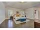 Luxurious main bedroom suite with tray ceilings, hardwood floors, and natural light at 452 Brushstroke Se Ct, Marietta, GA 30067