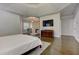 Spacious main bedroom with tray ceiling, sitting area with fireplace, and dark hardwood floors at 452 Brushstroke Se Ct, Marietta, GA 30067