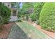 Peaceful side yard featuring a well-manicured lawn and mature trees for a tranquil outdoor space at 452 Brushstroke Se Ct, Marietta, GA 30067