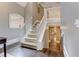 Carpeted staircase and landing with a white banister, and view into a hallway with hardwood floors at 452 Brushstroke Se Ct, Marietta, GA 30067