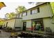 Two-story home with large picture window, cozy back patio, and lush greenery at 5041 Rockborough Trl, Norcross, GA 30071