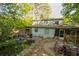 Exterior view of a two-story house with a backyard featuring a pond at 5041 Rockborough Trl, Norcross, GA 30071