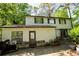 Charming two-story home featuring light siding, a cozy back patio, and lush greenery at 5041 Rockborough Trl, Norcross, GA 30071