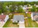 Aerial view of a well-maintained single-Gathering home with a large, green front yard and mature trees at 5069 Luxford Dr, Douglasville, GA 30135