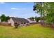 Spacious backyard with lush green grass, a patio with umbrellas, and a wooden privacy fence at 5069 Luxford Dr, Douglasville, GA 30135