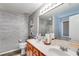 Bathroom with double sinks, modern vanity, and wood-look tile accents at 5069 Luxford Dr, Douglasville, GA 30135